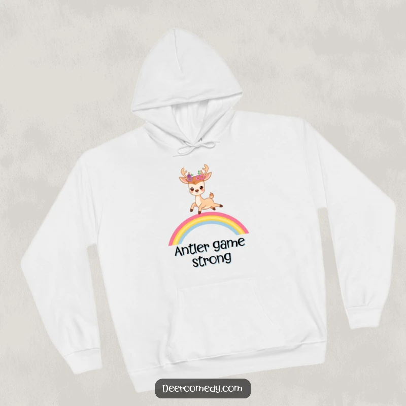 Funny hoodie featuring a cute deer with flowers in its antlers joyfully leaping high over a bright, beautiful rainbow.