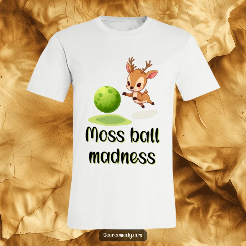 Funny t-shirt depicting a little deer energetically pursuing a round, bouncy ball made entirely of moss.